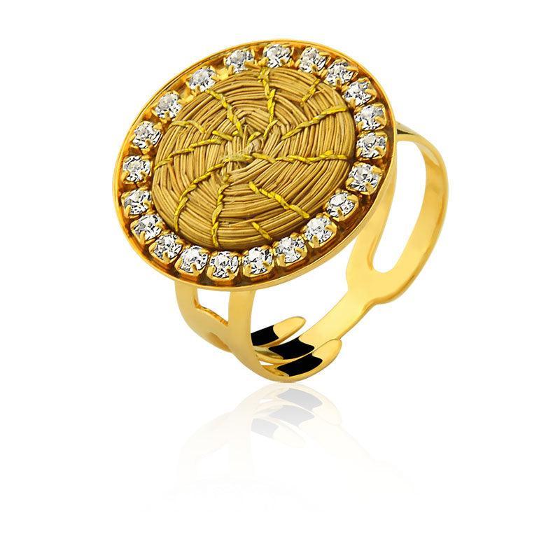 Gold mandala ring with woven center and crystal zirconia accents on white background