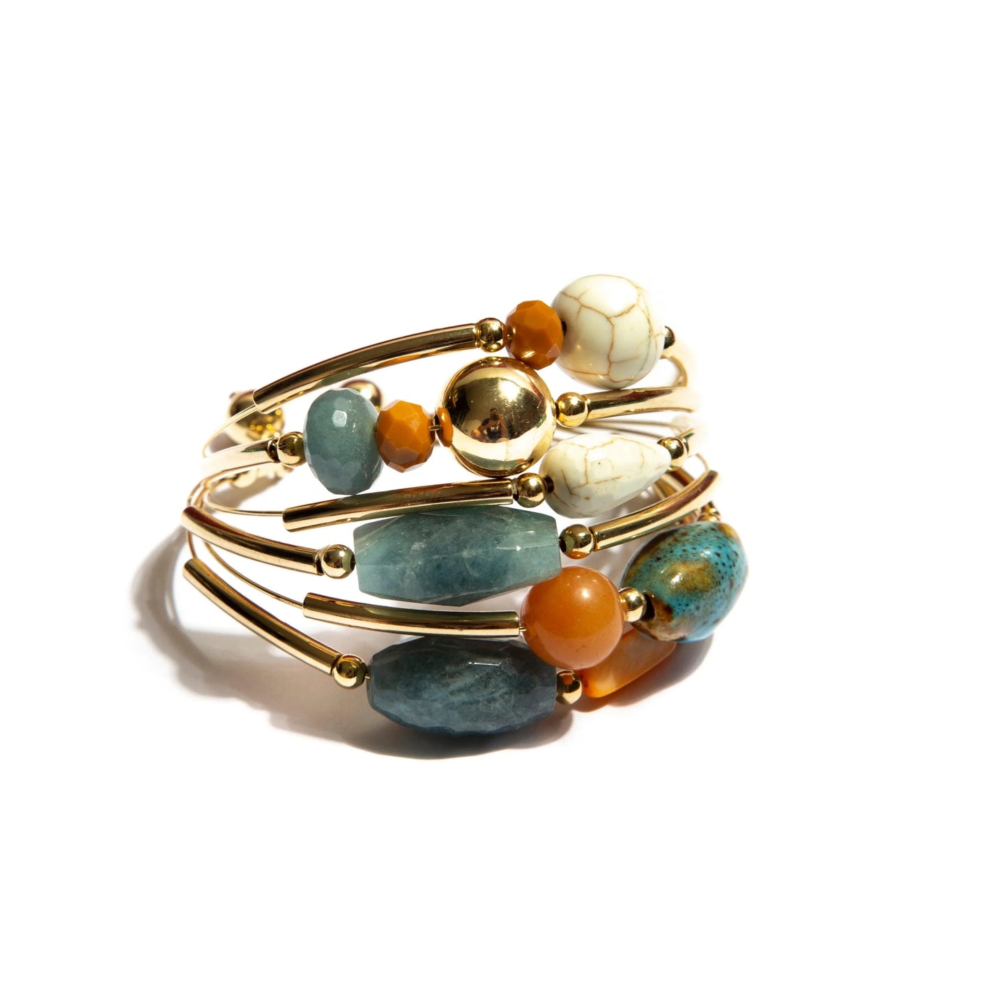 Gold bangle bracelet with multicolored natural stones and beads on white background