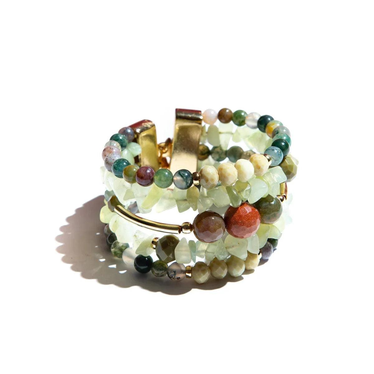 Green crystal and agate beaded bracelet with gold accents on white background