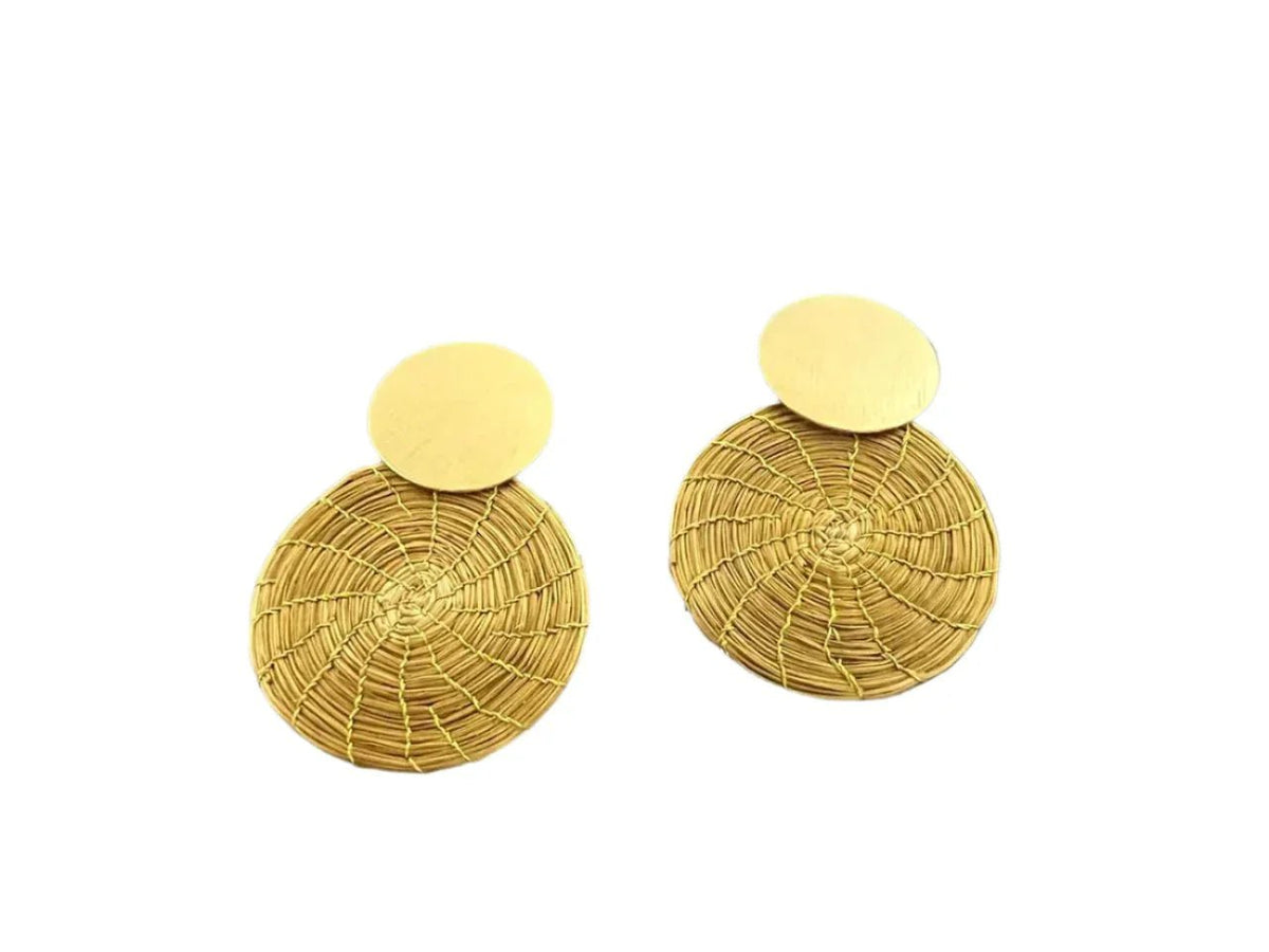 Handcrafted golden grass mandala earrings with circular woven pattern on white background